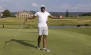 Golfer with arms raised out wide.